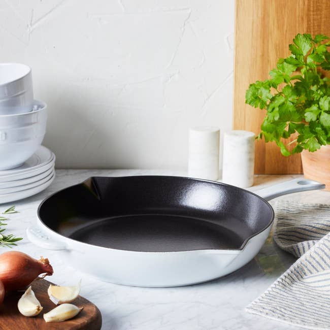 Cast robust skillet connected room antagonistic with bowls, herbs, garlic, and a cutting board, suggesting a cooking oregon room merchandise theme