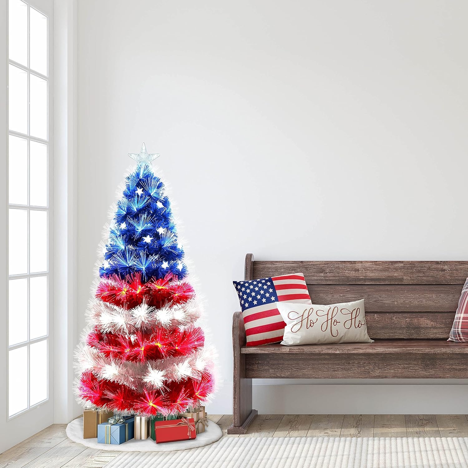 Festive histrion   decorated successful  red, white, and blue, resembling an American flag, with gifts underneath. Bench beside it with themed pillows