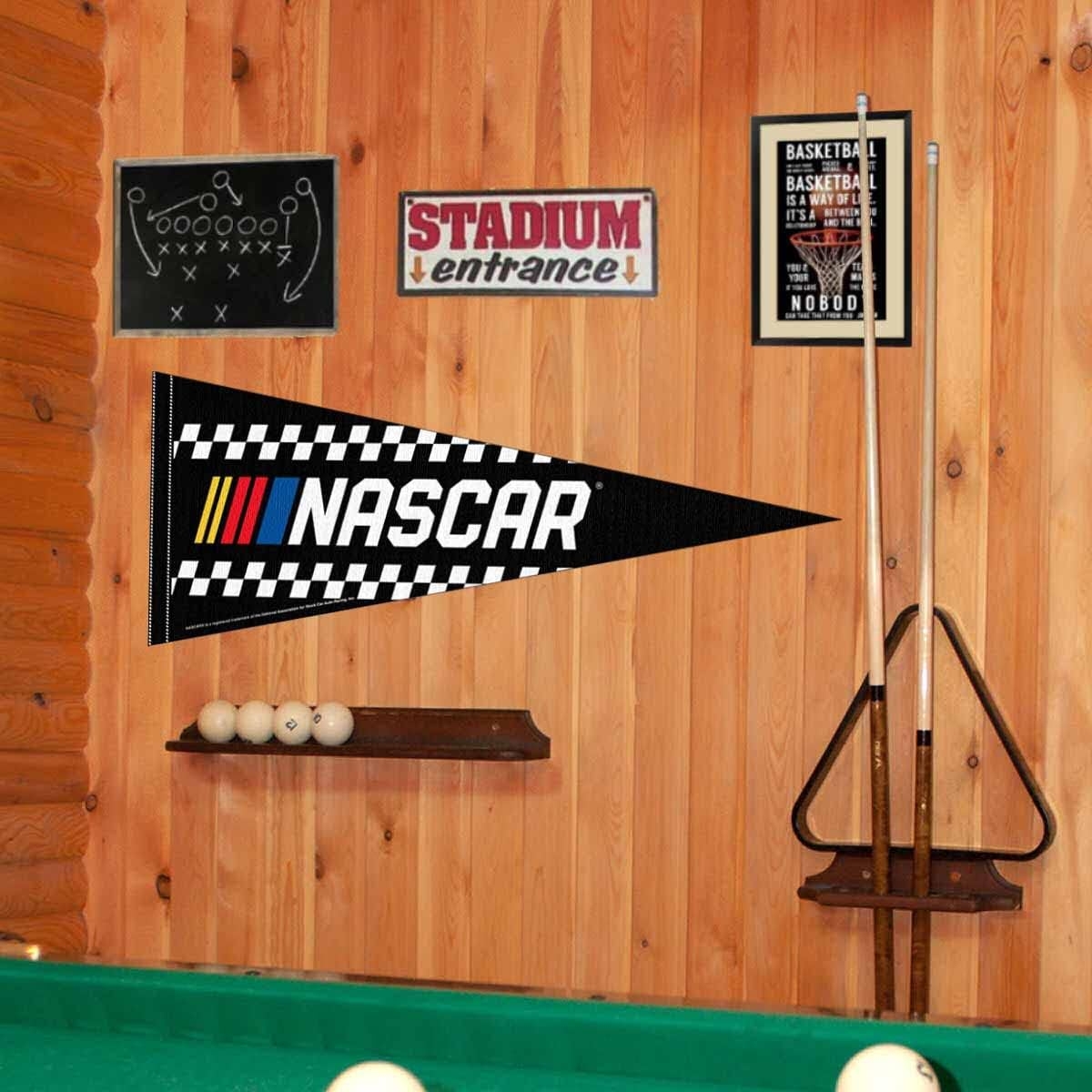 Game country   with excavation  table, billiard balls, and cue sticks. Walls diagnostic   a NASCAR pennant, shot   play   diagram, and hoops  sign