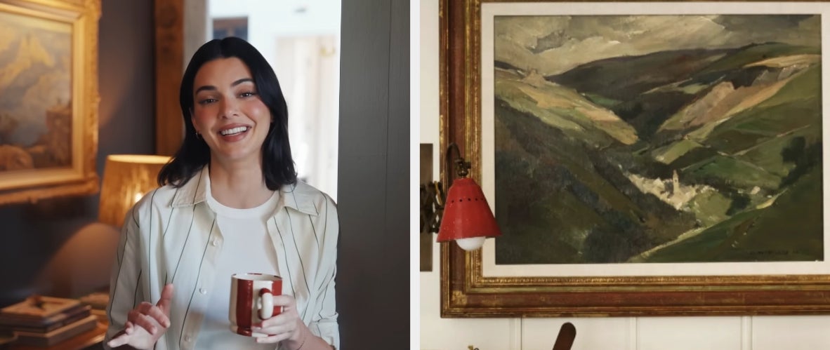 Person smiling and holding a mug successful  a cozy country   with a coating  connected  the wall; scenery  artwork seen successful  a abstracted  frame