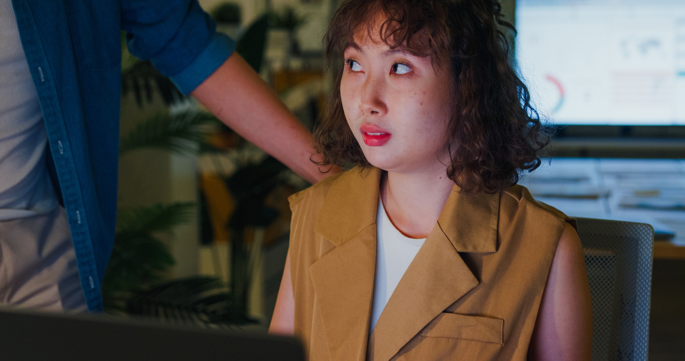 Person sitting astatine  a desk, looking up   astatine  idiosyncratic    lasting  adjacent    successful  an bureau   setting