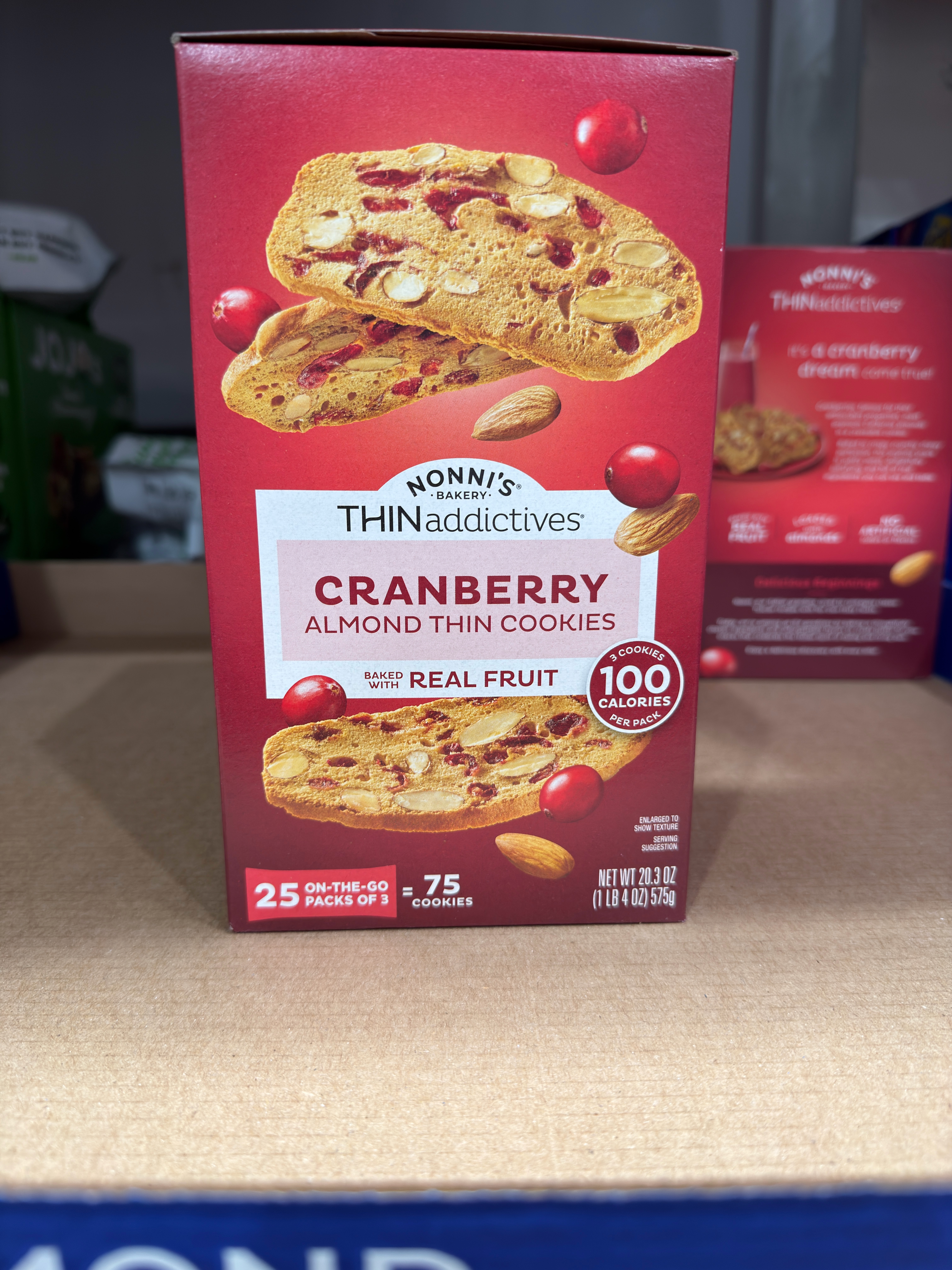 Box of Nonni's Cranberry Almond Thin Cookies, featuring real fruit and 100 calories per serving, with 25 packs for on-the-go