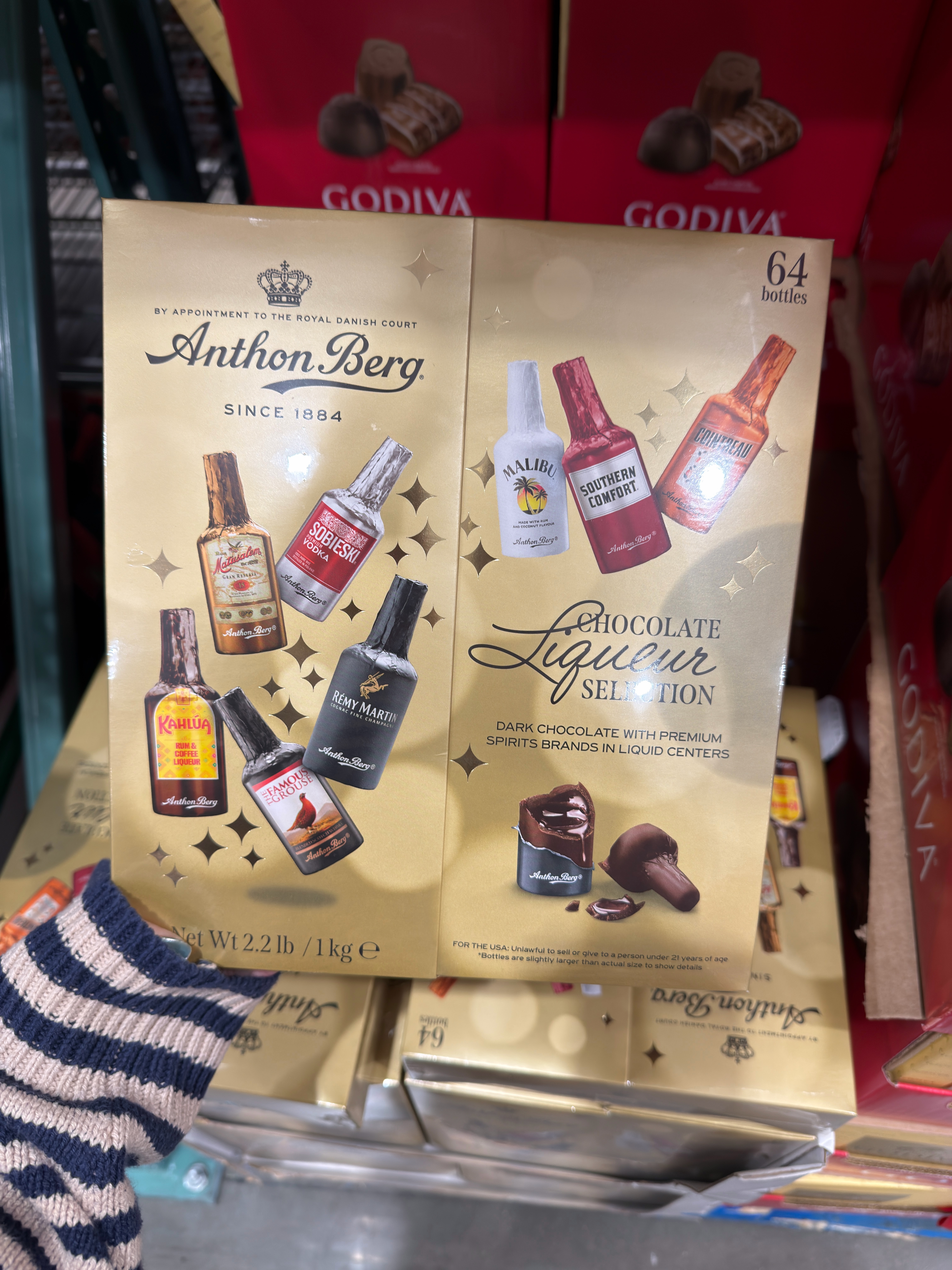Box of Anthon Berg chocolate liqueurs featuring miniature bottles of spirits next to chocolates
