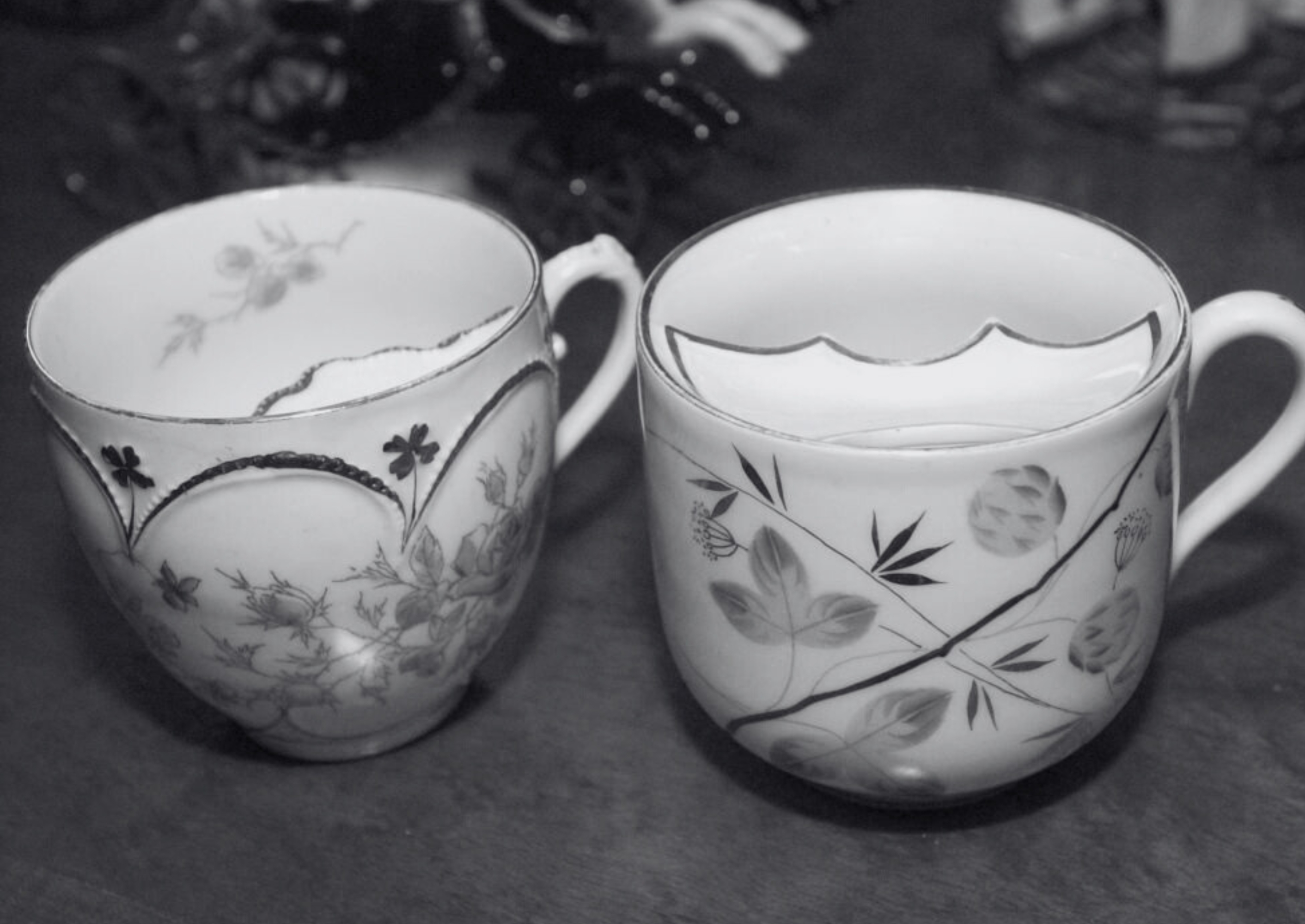 Two vintage teacups with intricate floral patterns beryllium   connected  a table, showcasing delicate plan  features