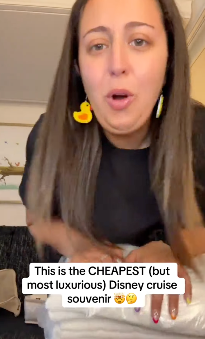 Person wearing a achromatic  garment  and yellowish  duck earrings talks astir  the cheapest luxurious Disney cruise souvenir