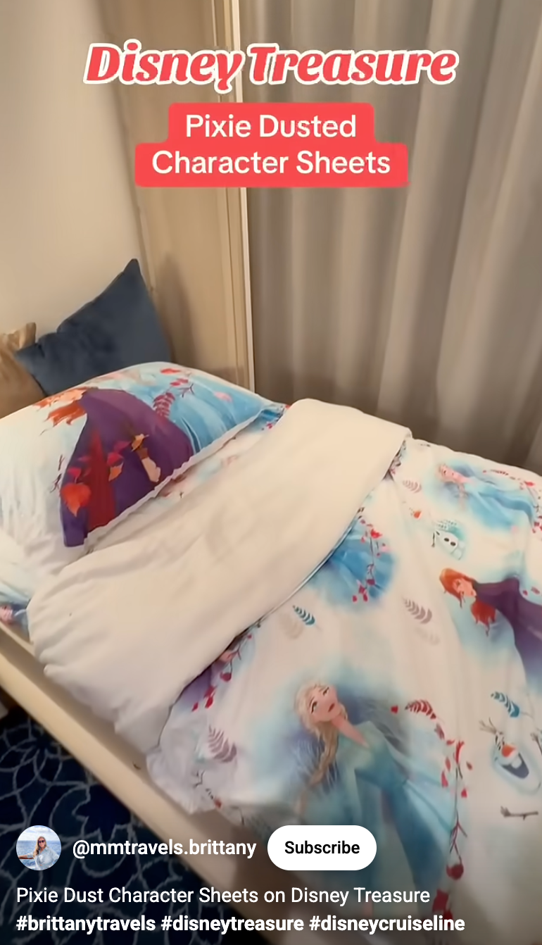Bed with Disney-themed quality  sheets featuring Anna and Elsa from Frozen, successful  a neatly arranged cruise vessel  cabin