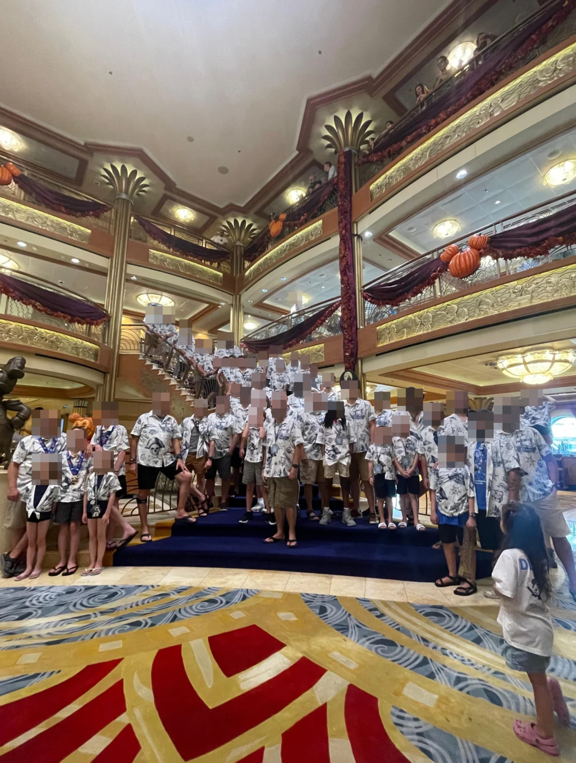 A ample  radical  wearing akin  outfits poses wrong  a multi-level, elegantly decorated gathering  with ornate railings and a expansive  staircase