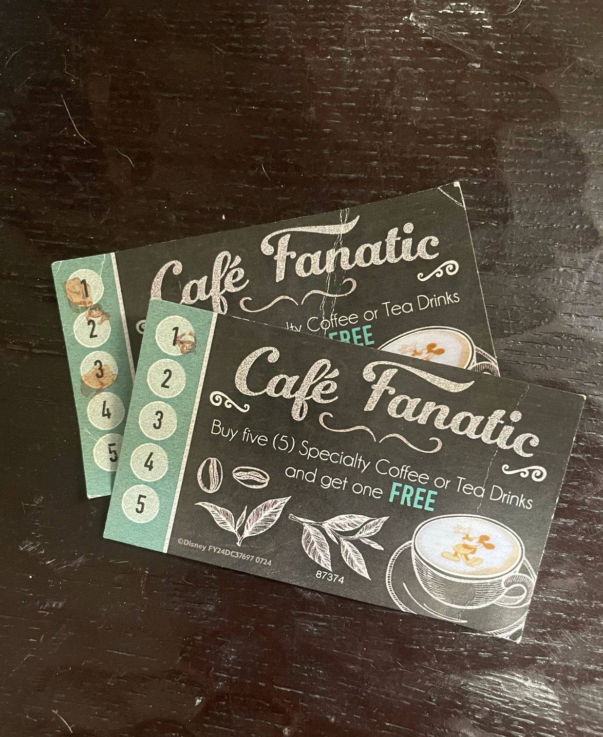 Two java  loyalty cards from Café Fanatic, each   displaying stamps for specialty java  purchases; 1  paper  offers a escaped  portion  aft  5  stamps