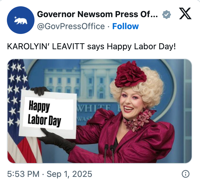 A idiosyncratic successful a flamboyant outfit with a ample chapeau holds a motion speechmaking "Happy Labor Day" successful beforehand of a podium