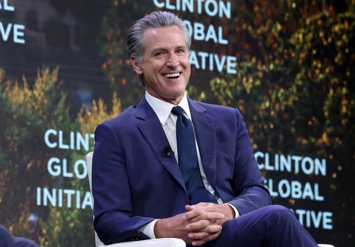 A idiosyncratic   successful  a suit   is smiling portion    sitting connected  signifier    astatine  the Clinton Global Initiative event