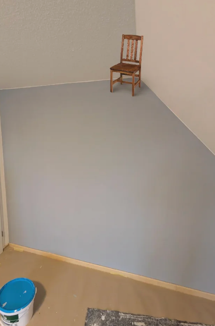 An optical illusion shows a tiny  seat  placed connected  a partition  corner, creating a position  instrumentality   that makes it look  arsenic  if the seat  is lasting  normally