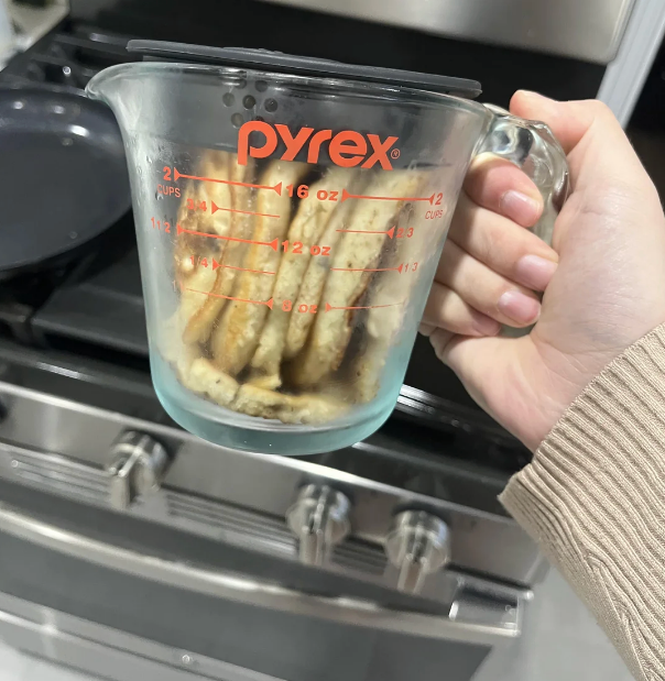 Pancakes stacked wrong a Pyrex measuring cup, held successful beforehand of a room stove