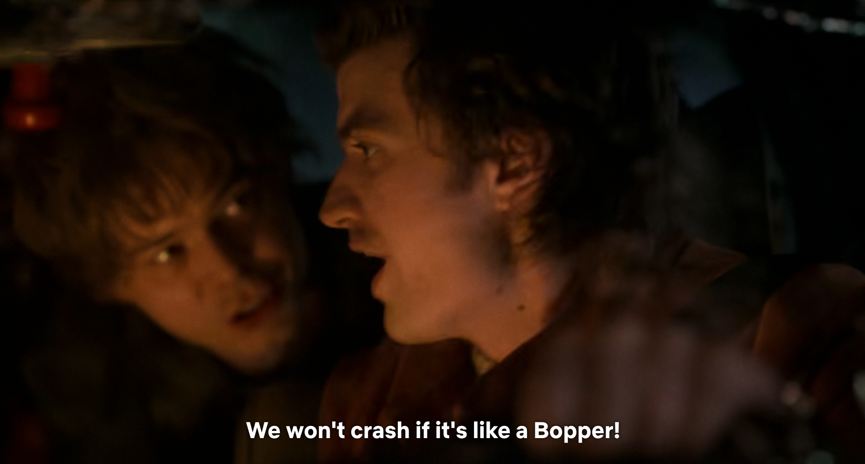 Two people in a dark setting; one says, "We won't crash if it's like a Bopper!"