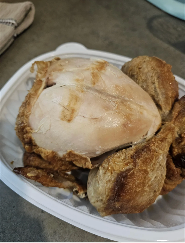 Cooked rotisserie chickenhearted with tegument picked off, laid successful a integrative instrumentality connected a room countertop