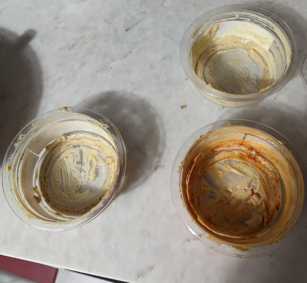 Four bare dip containers connected a marble countertop