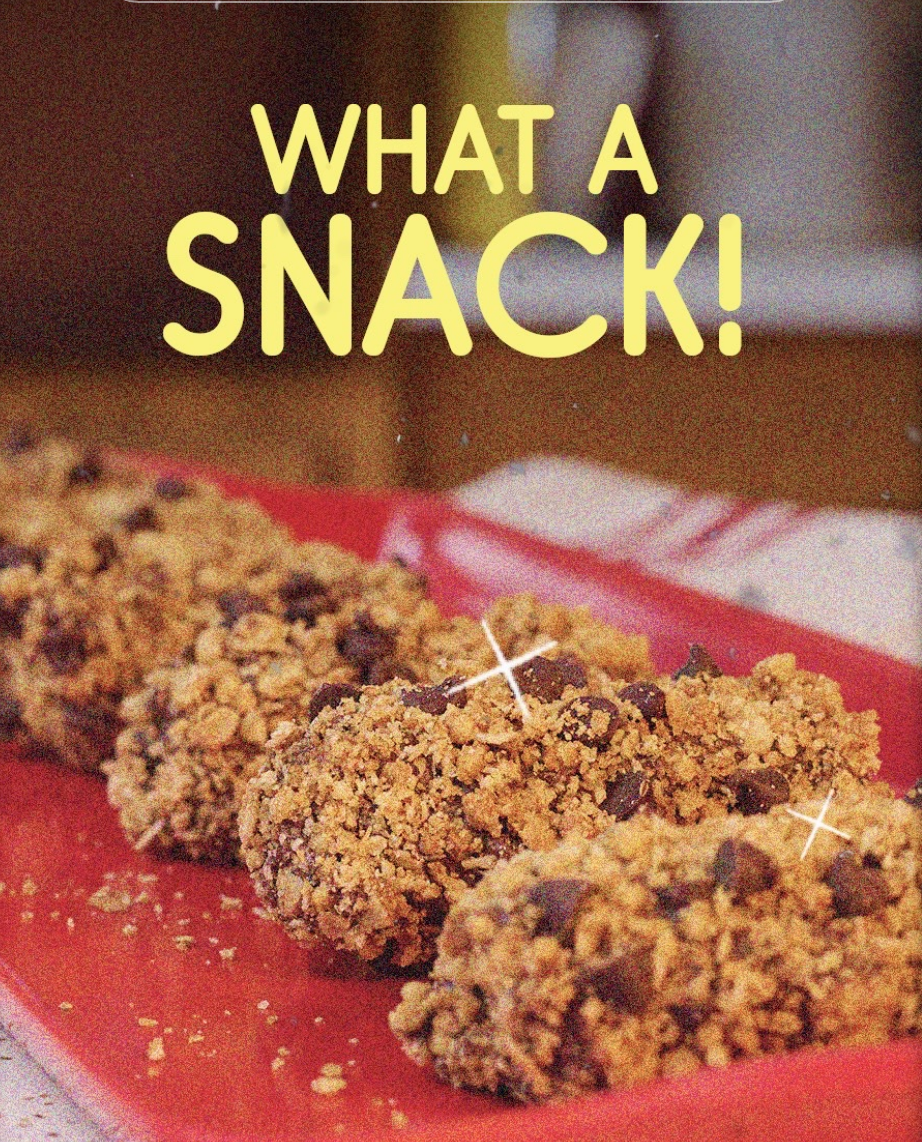 Granola bars on a red tray with chocolate chips. Text above reads "WHAT A SNACK!"