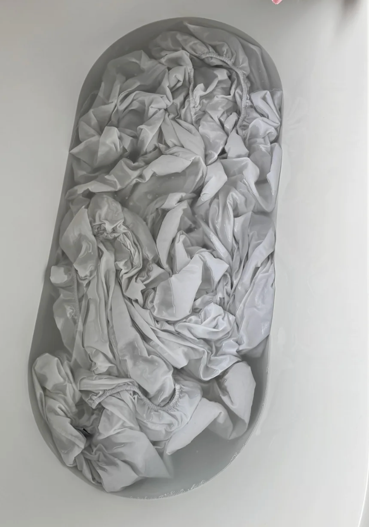 Fabric soaking successful  a bathtub filled with water