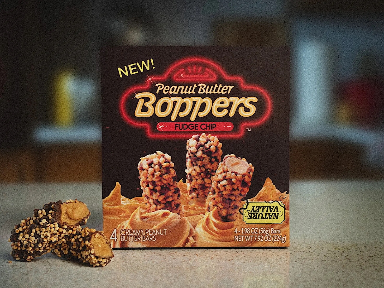 Box of Peanut Butter Boppers fudge chip bars with peanut butter swirls and three bars displayed on the front