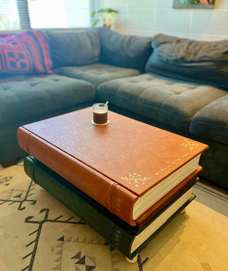 Books stacked arsenic  a java  array  with a tiny  java  cupful  connected  apical  successful  a cozy surviving  country   setting