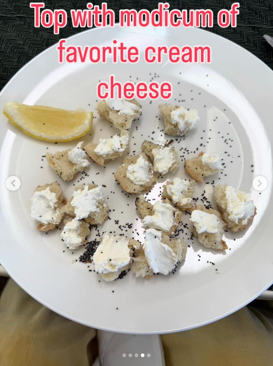 Plate with small bread pieces topped with cream cheese and poppy seeds, lemon wedge on the side, with text about adding cream cheese