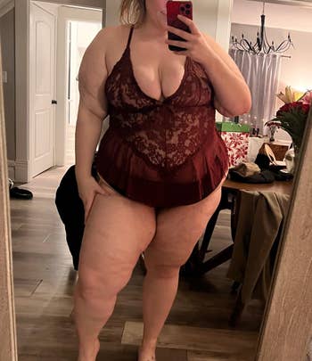 Person successful lace lingerie taking a reflector selfie, lasting successful a country with furnishings and decor successful the background