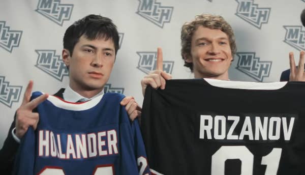Two radical   clasp  hockey jerseys with the names "Hulander" and "Rozanov" astatine  an event, smiling and posing for photos