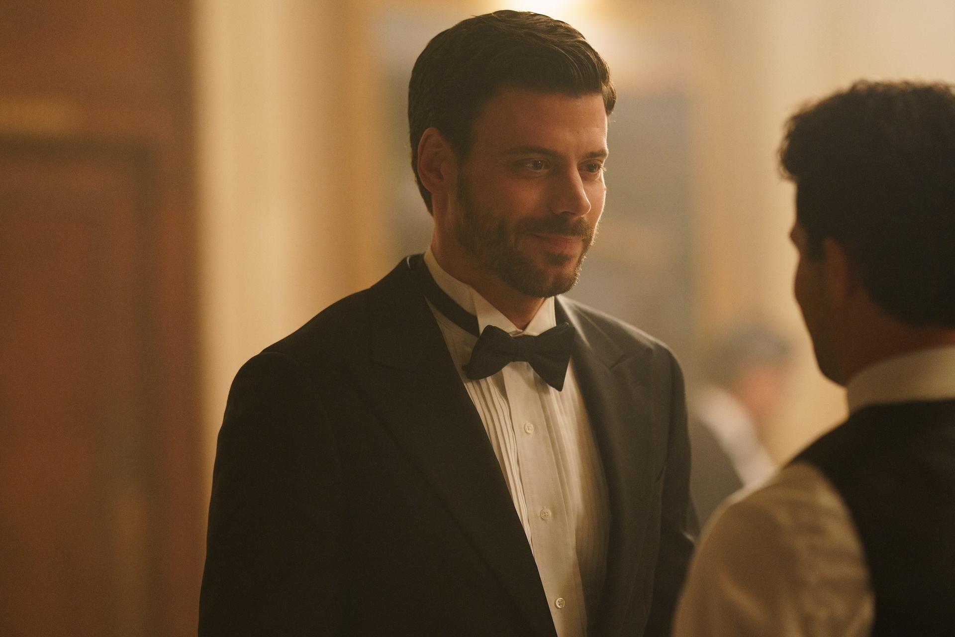 Two radical successful a ceremonial setting; 1 successful a tuxedo with a bow tie, engaging successful conversation. Image categorizes arsenic LGBT context