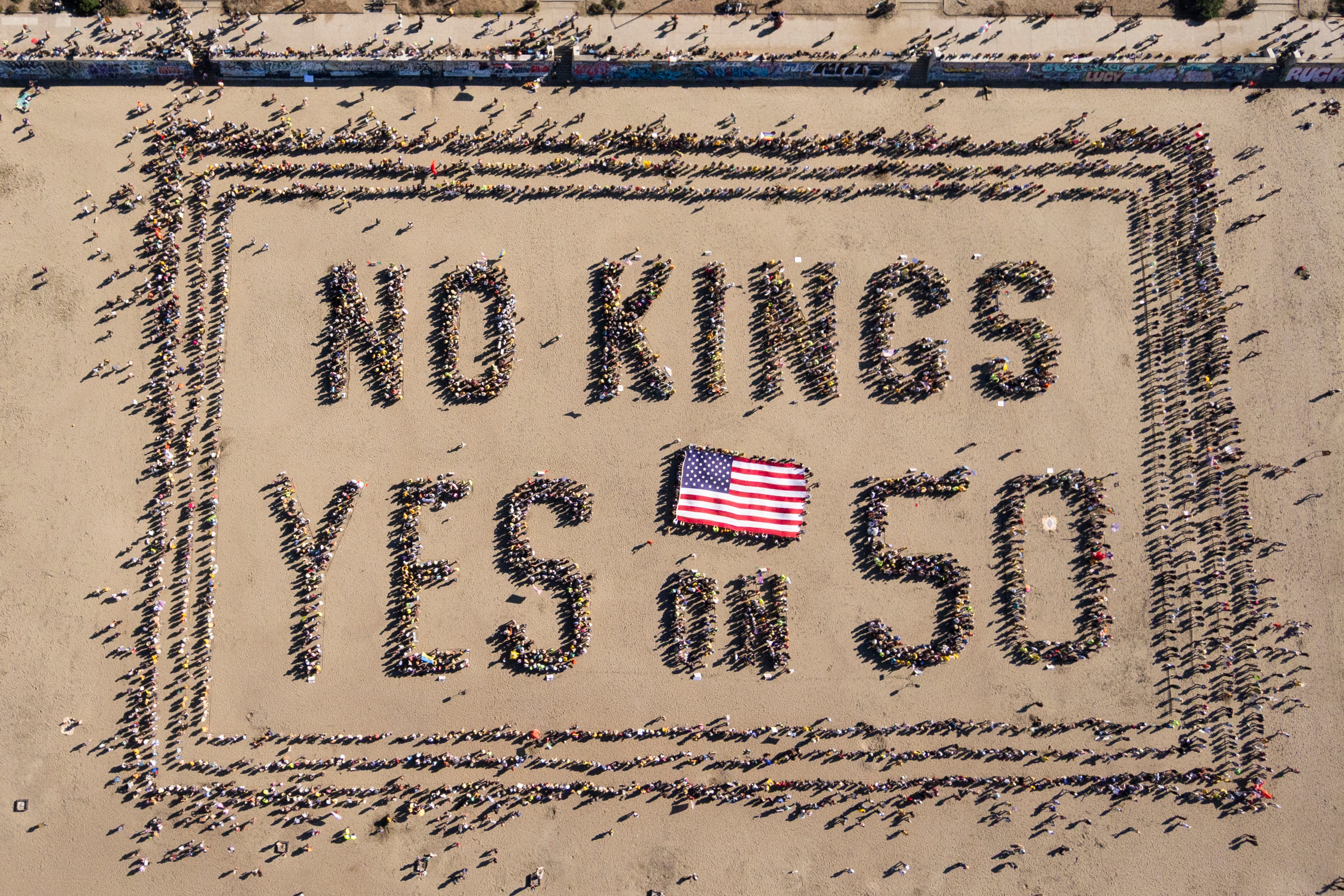 Aerial presumption of a ample radical of radical connected the formation forming the substance "NO KINGS YES connected 50" with a U.S. emblem astatine the center