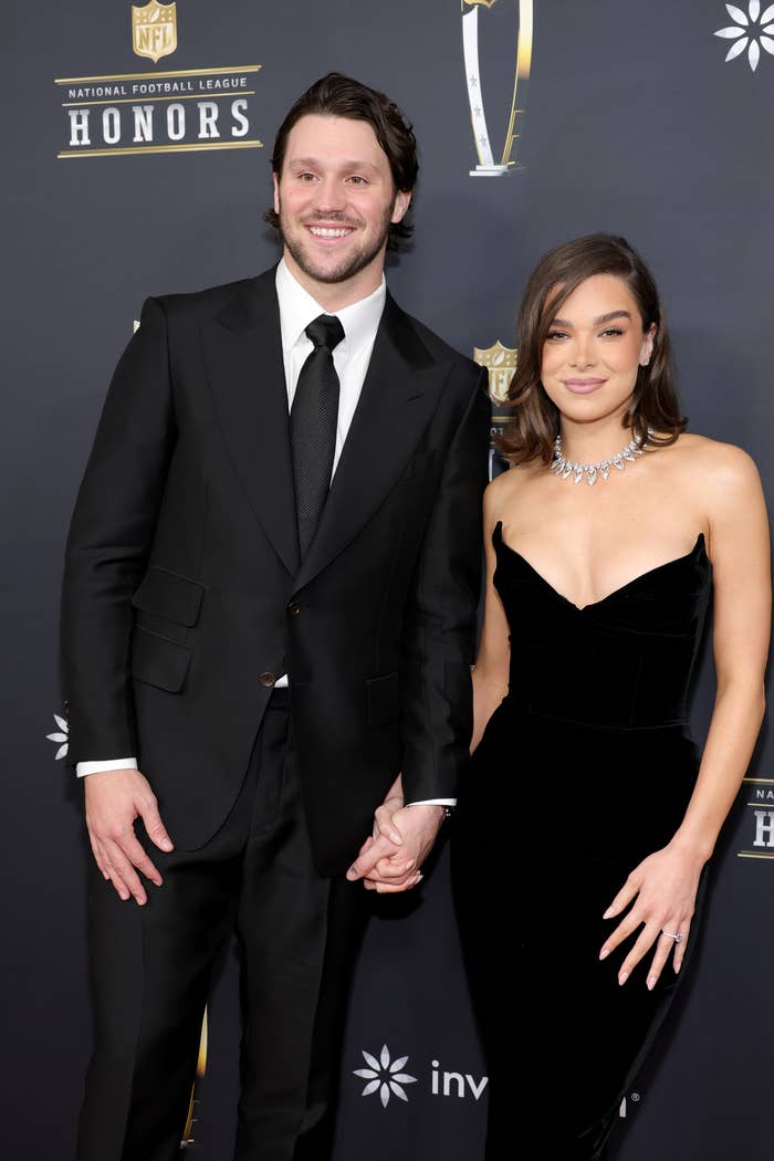 Josh Allen successful  a achromatic  suit   and Hailee Steinfeld successful  a strapless gown lasting  connected  a ceremonial  lawsuit   reddish  carpet, posing and smiling for photos