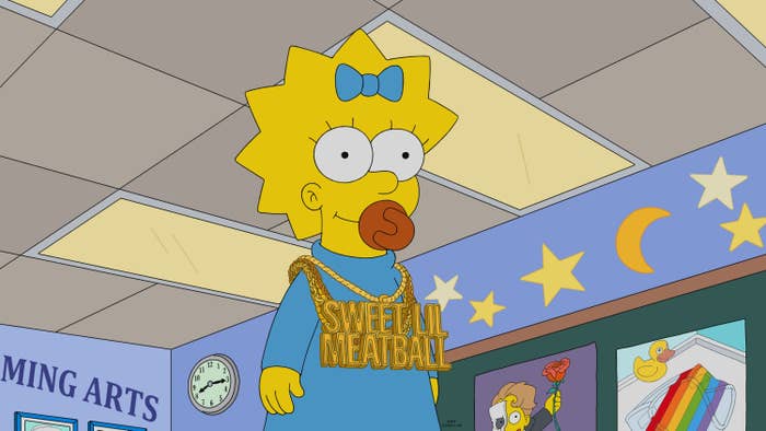 Maggie Simpson wearing a pacifier and ample  novelty necklace with "Sweet Lil Meatball" text, lasting  successful  a cartoon schoolroom  setting
