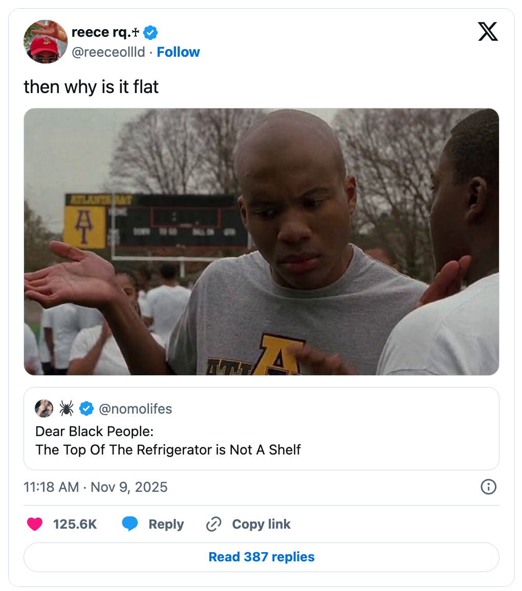 A idiosyncratic looks confused portion different gestures towards a substance discussing the refrigerator apical not being a shelf