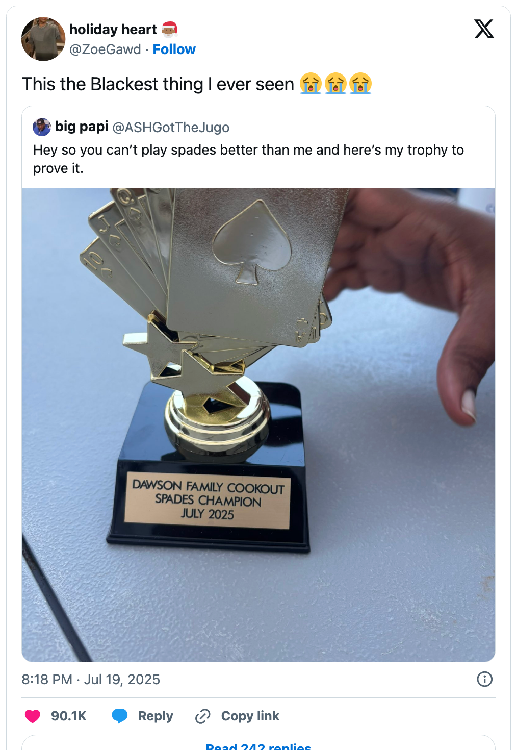 Trophy with paper suite symbols labeled "Dawson Family Cookout Spades Champion July 2025" held by a person's hand