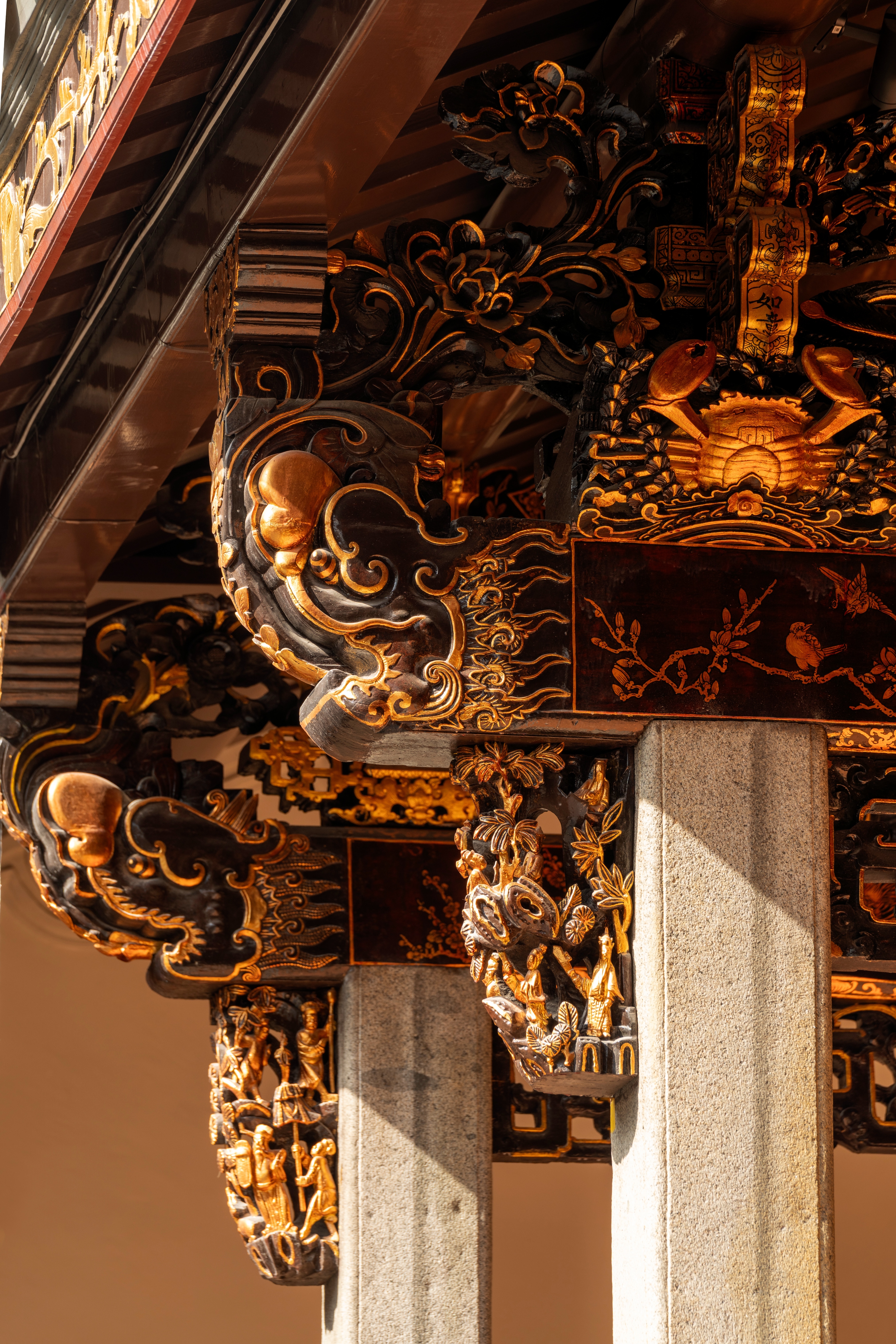 Ornate architectural details, featuring intricate carvings and gilded designs on columns, showcasing traditional craftsmanship