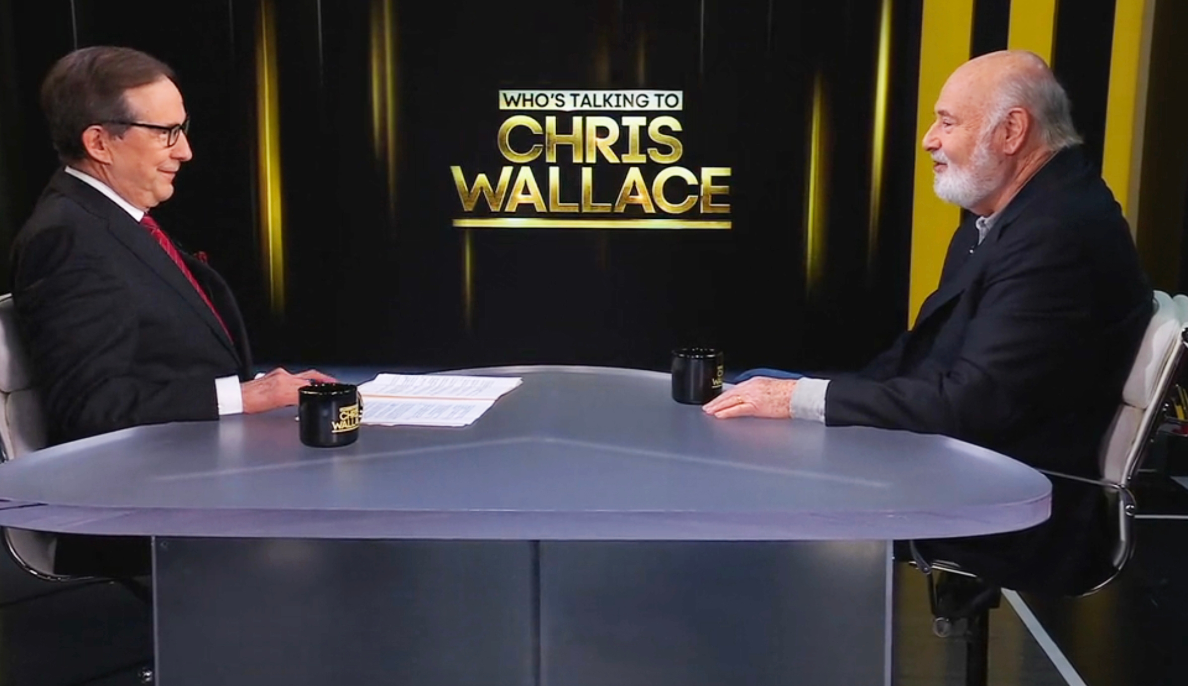 Two men seated crossed from each different connected a speech amusement set, with a motion speechmaking "Who's Talking to Chris Wallace."