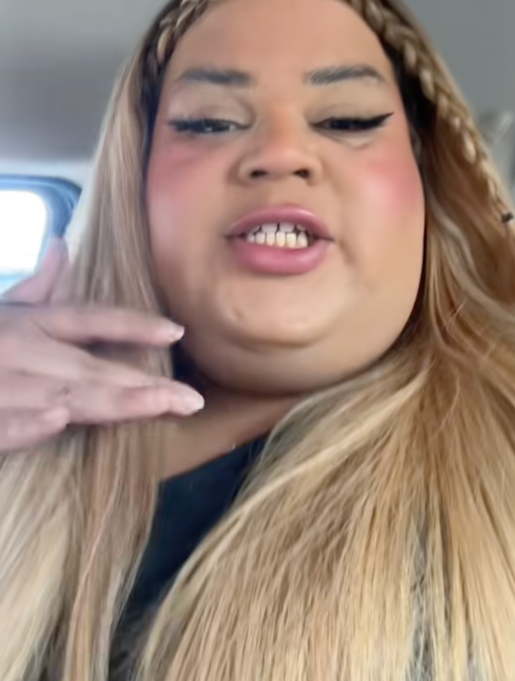 Person with agelong  hairsbreadth  and braided headband successful  a car, speaking and gesturing with hand, wearing eyeliner and lipstick