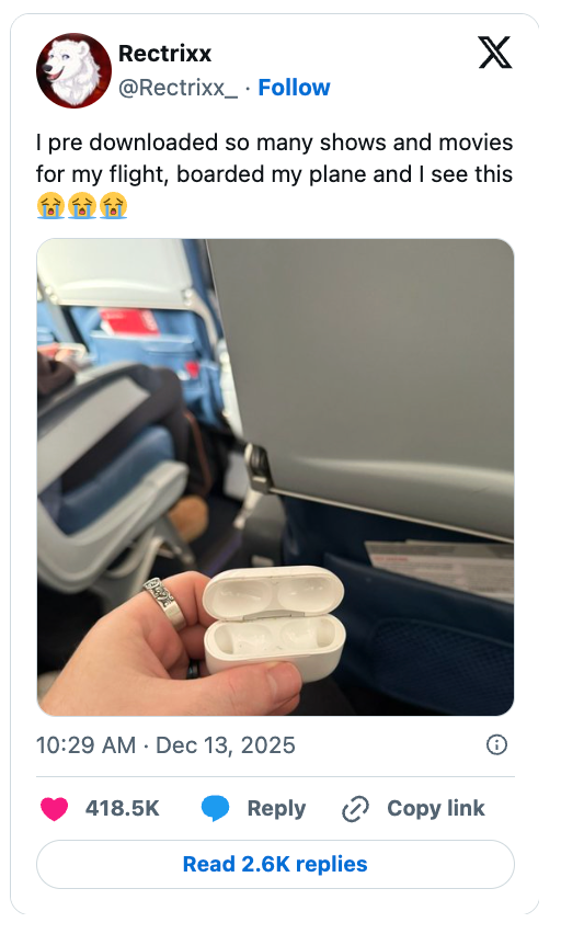 An unfastened  earbud lawsuit  with nary  earbuds inside, held by a idiosyncratic   connected  an airplane