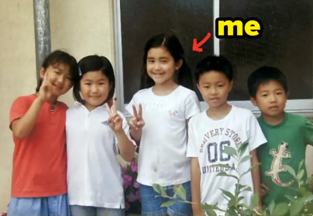 Five children, standing in a row, smile for a photo. A red arrow points to the girl in the center labeled "me."