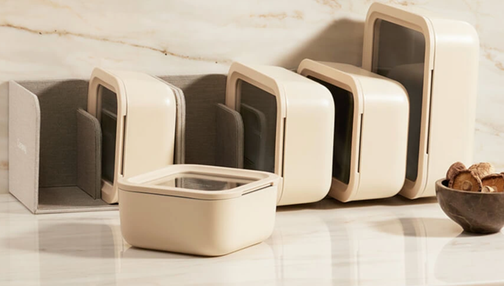 Minimalist retention  containers with transparent lids connected  a countertop adjacent  to a tiny  vessel  of cookies