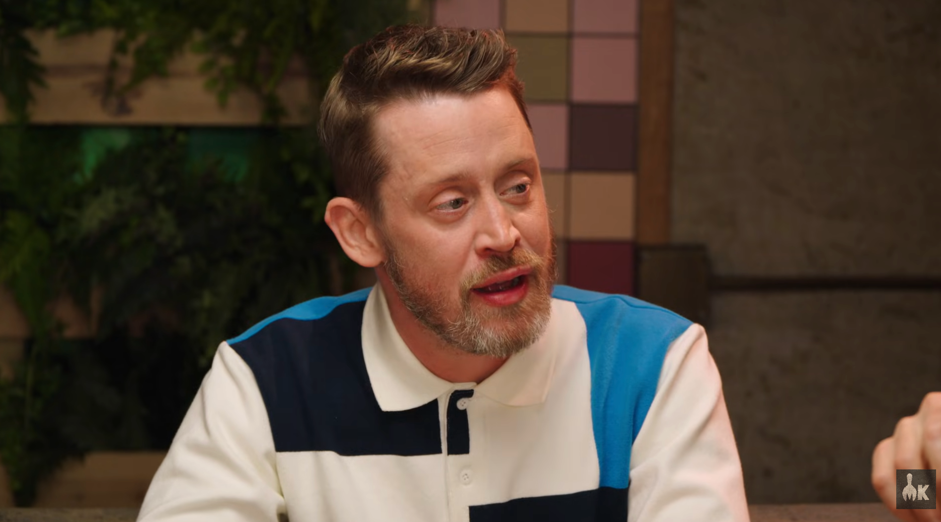 Person with abbreviated  hairsbreadth  and beard, wearing a casual polo shirt, engaged successful  a treatment  indoors