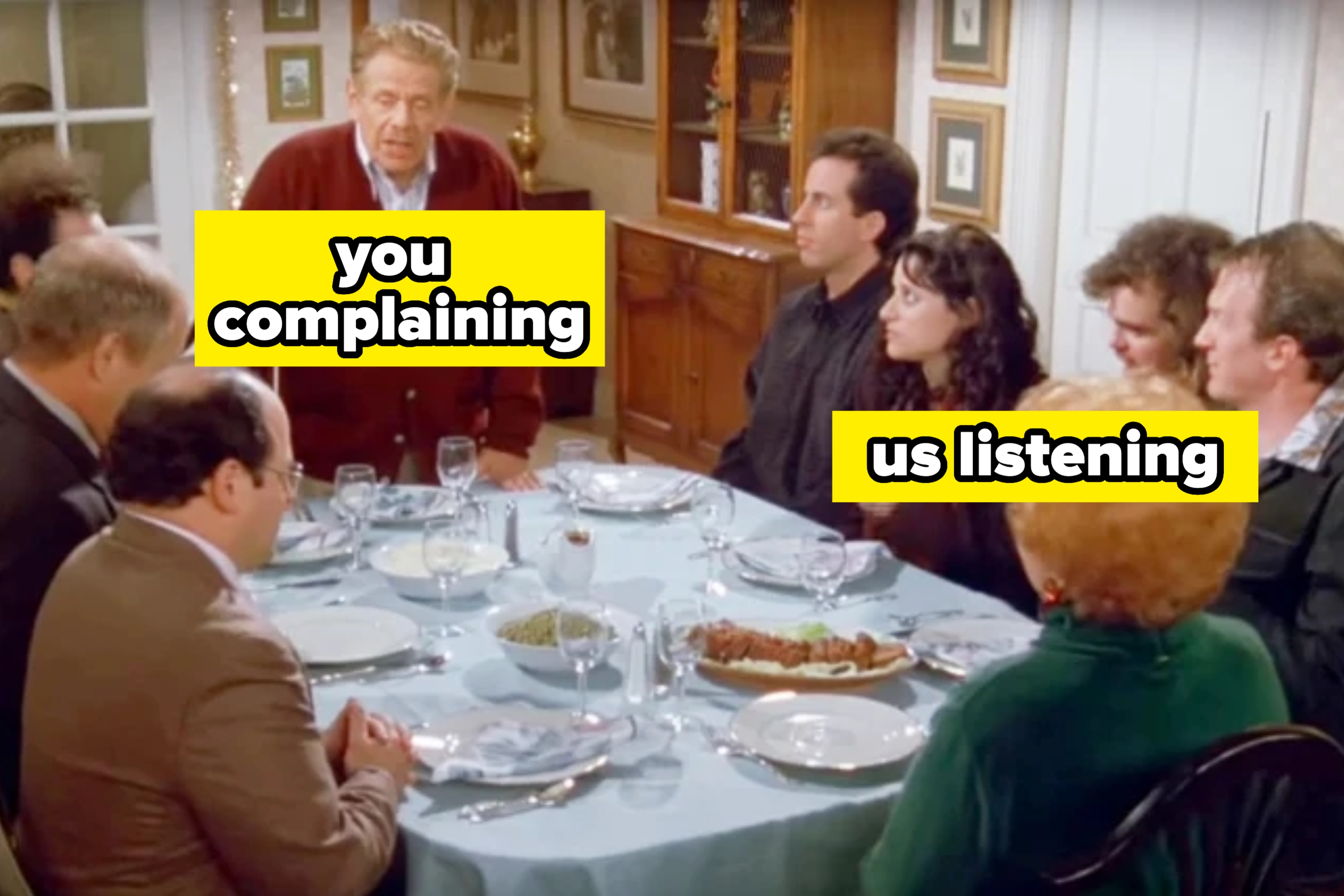 A group of people sitting around a dining table with text: "you complaining" and "us listening," referencing a humorous discussion scenario