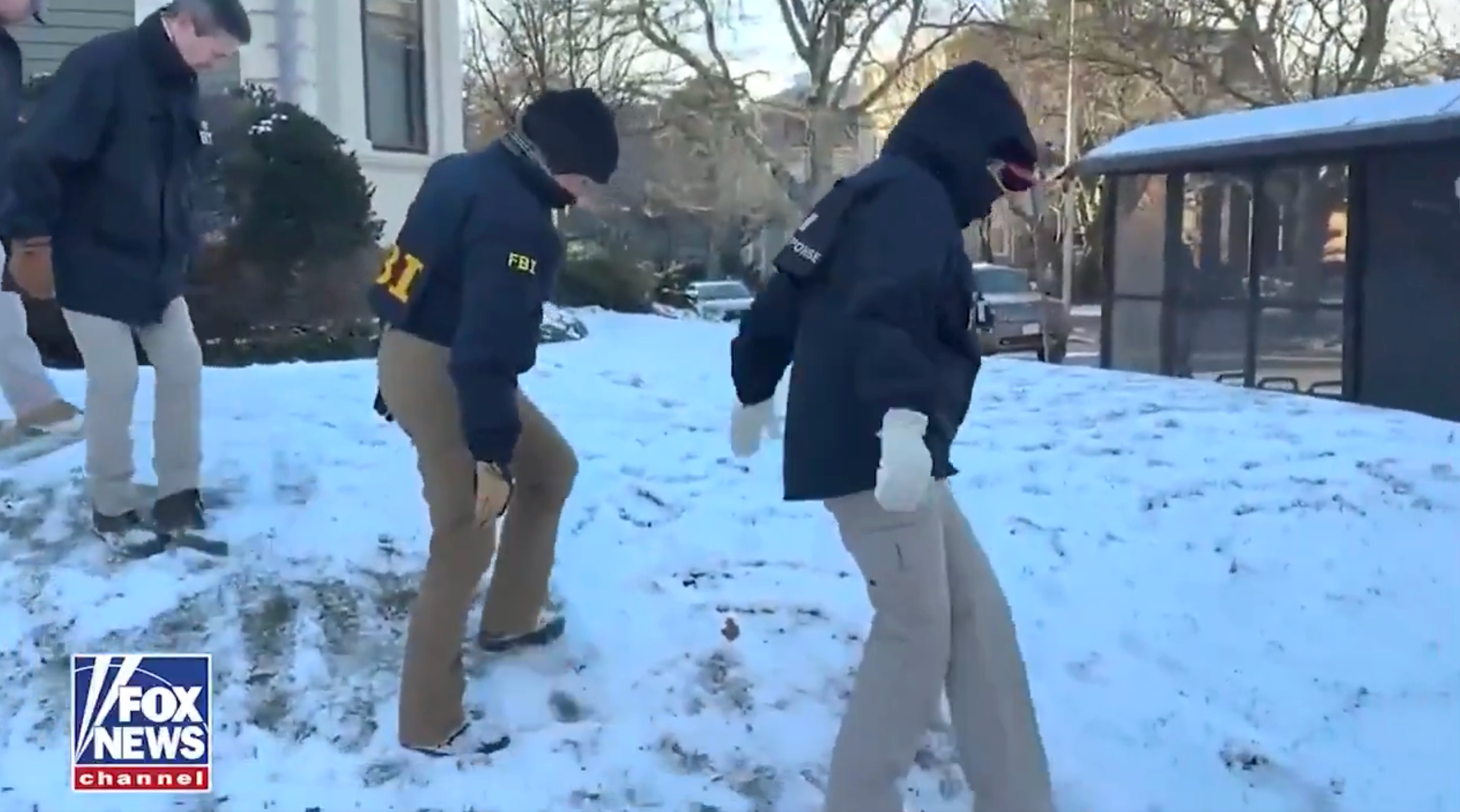 FBI agents walking cautiously connected a snowy lawn