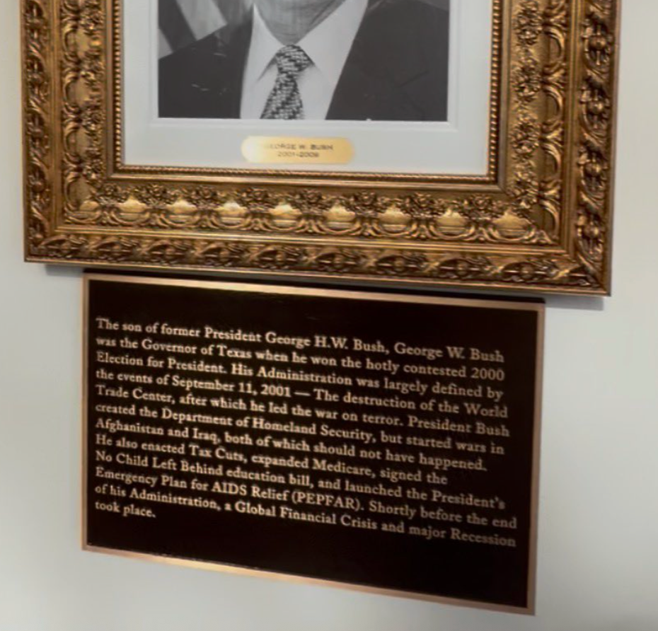 Plaque honoring erstwhile President George W. Bush, detailing his career, presidency highlights, and cardinal legislative efforts including the warfare connected terror