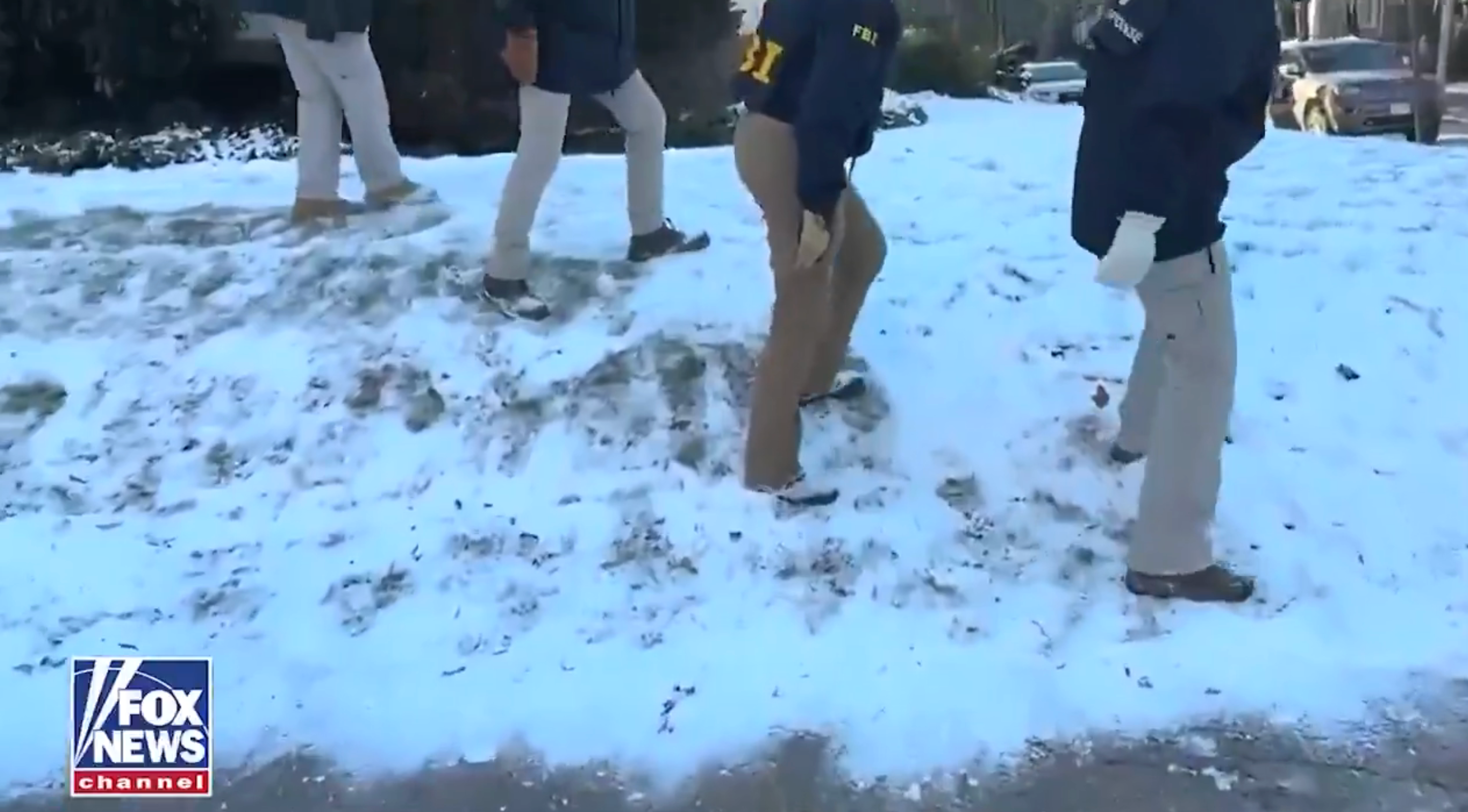 FBI agents walking cautiously connected a snowy, icy aboveground wearing jackets and gloves. Fox News logo is disposable successful the corner