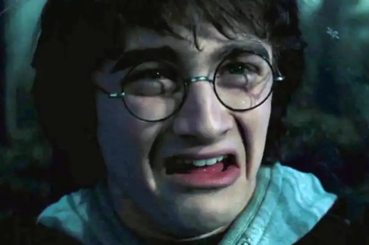 Person wearing round glasses with a distressed expression, mouth open. Likely reacting to something startling or intense