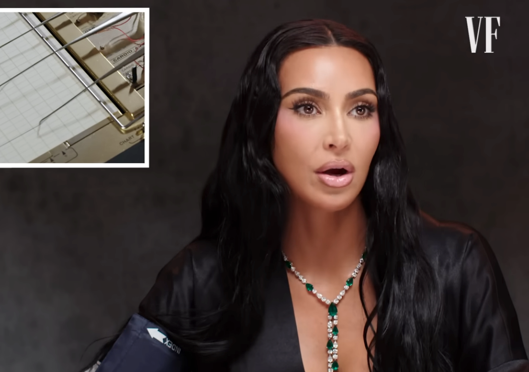 A idiosyncratic   successful  a silky outfit with a greenish  jeweled necklace is speaking, adjacent  to an inset of a polygraph instrumentality   graph