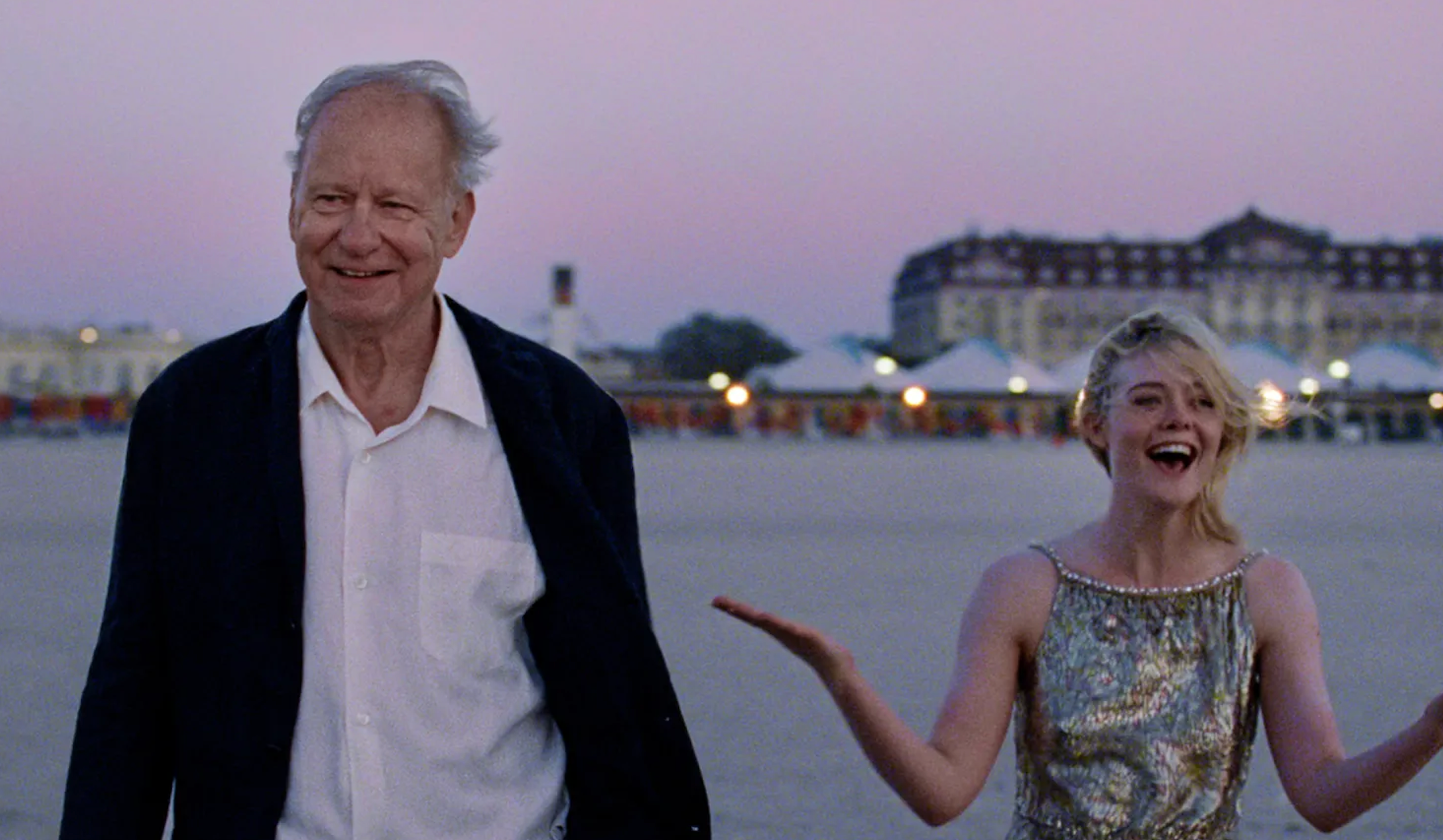 An older antheral   and a younger pistillate   successful  a sequined formal  basal   outdoors, smiling