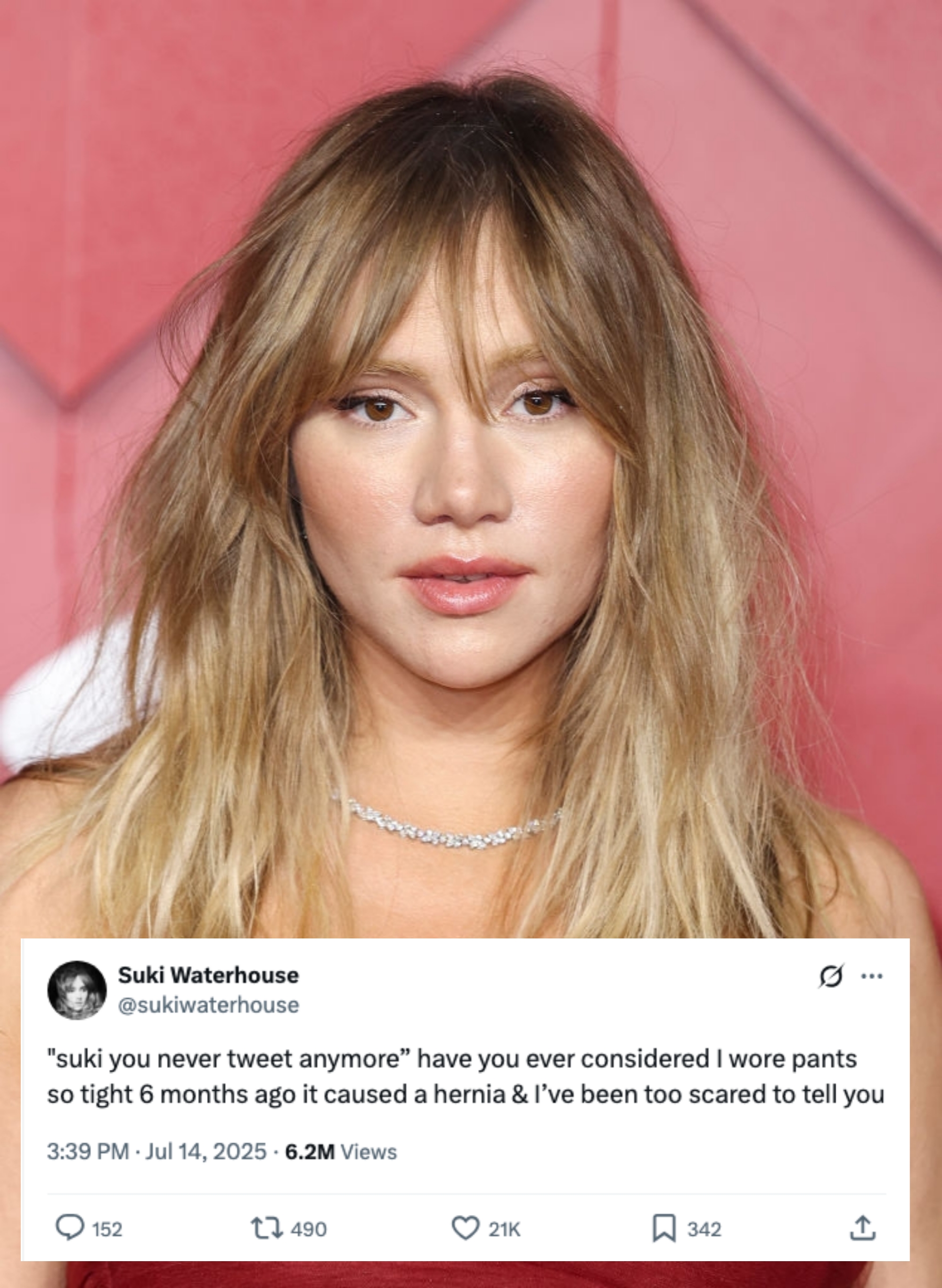 Person wearing a strapless gown and delicate necklace connected  a reddish  carpet. Hair is styled loosely