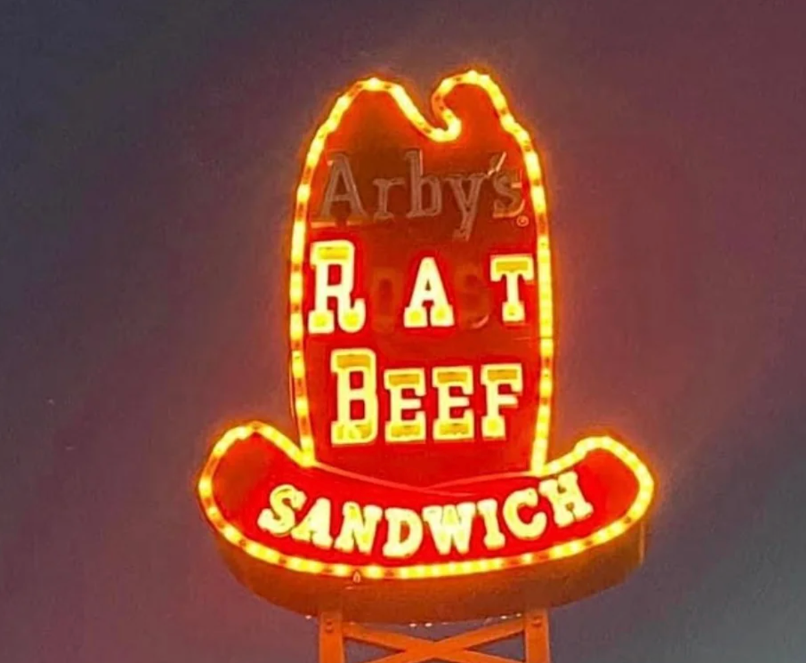 A motion   with neon lights partially speechmaking  "Rat Beef Sandwich," expected  to lucifer   an Arby's sign