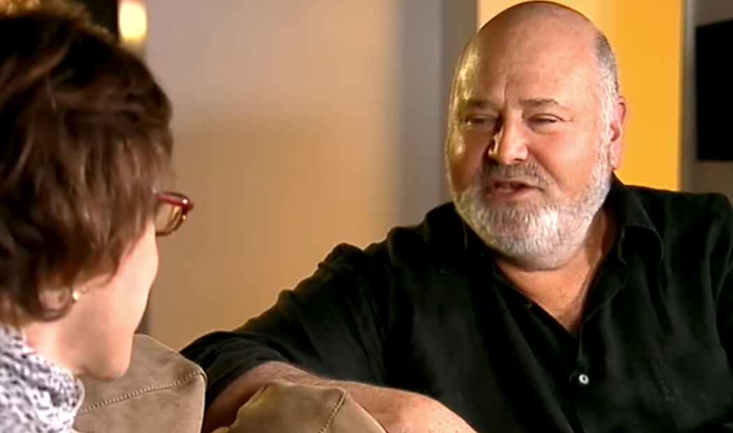 Two radical   sitting connected  a sofa  having a speech  successful  a casual setting