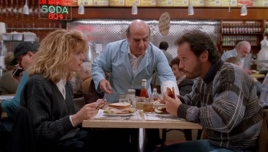 A edifice  country   with a waitress taking orders from a antheral   and pistillate   astatine  a diner table, featuring bustling inheritance  patrons